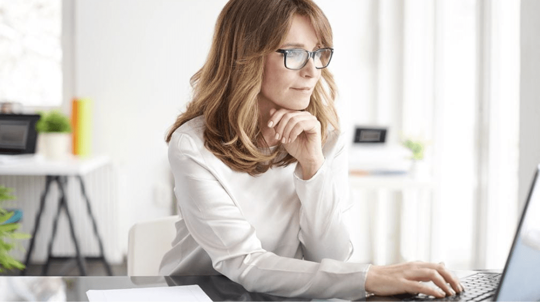 Woman with glasses on a laptop