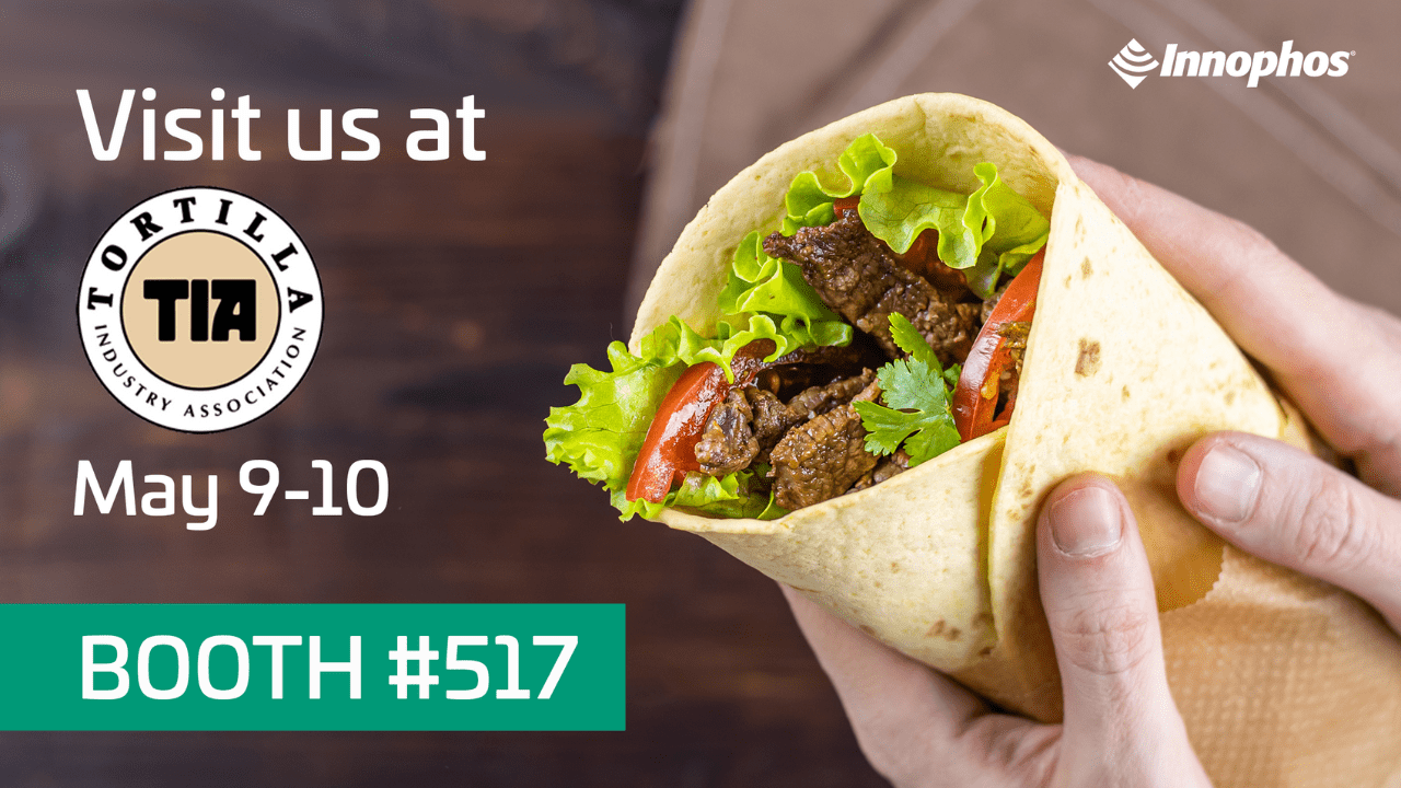 Hands holding a tortilla wrap sandwich